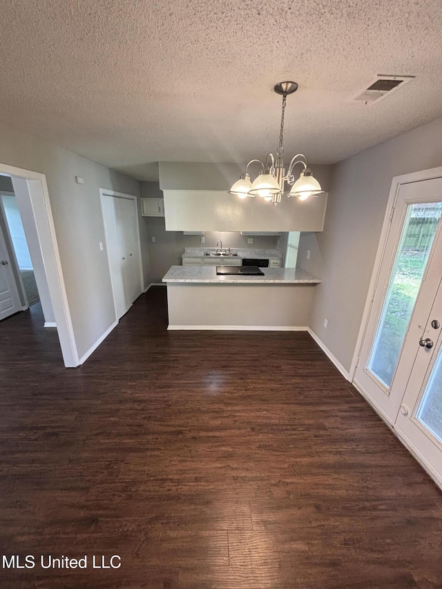 6405 Collinwood Rd, Horn Lake, MS 38637 - unfurnished dining area featuring baseboards, visible vents, a textured ceiling, and dark wood-type flooring