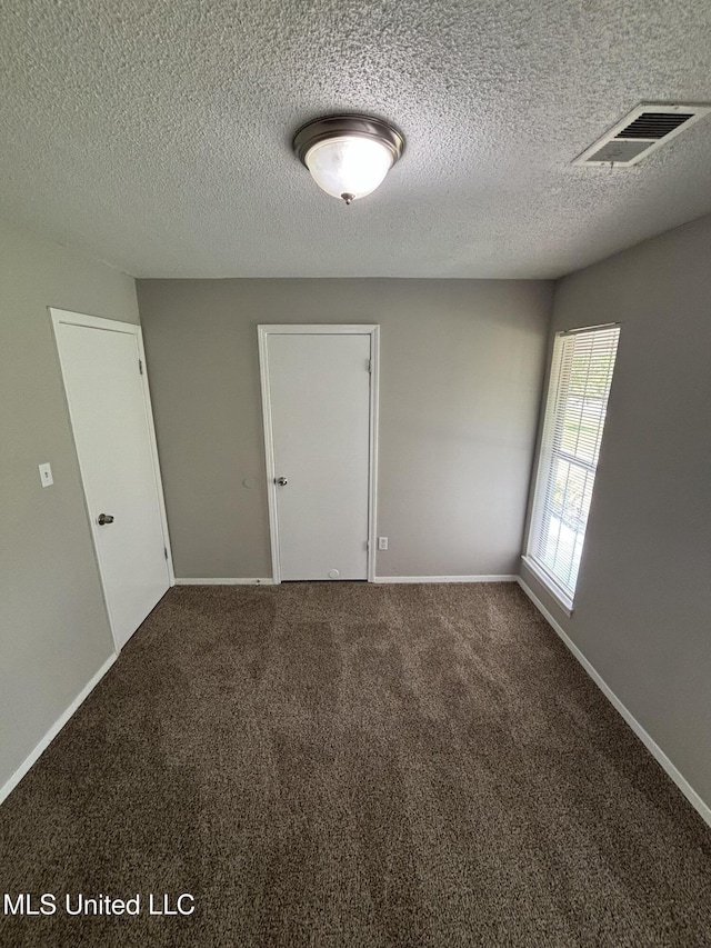 6405 Collinwood Rd, Horn Lake, MS 38637 - carpeted spare room featuring a textured ceiling, baseboards, and visible vents