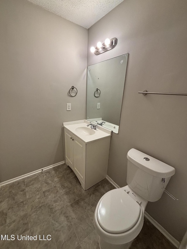 6405 Collinwood Rd, Horn Lake, MS 38637 - bathroom with toilet, a textured ceiling, baseboards, and vanity