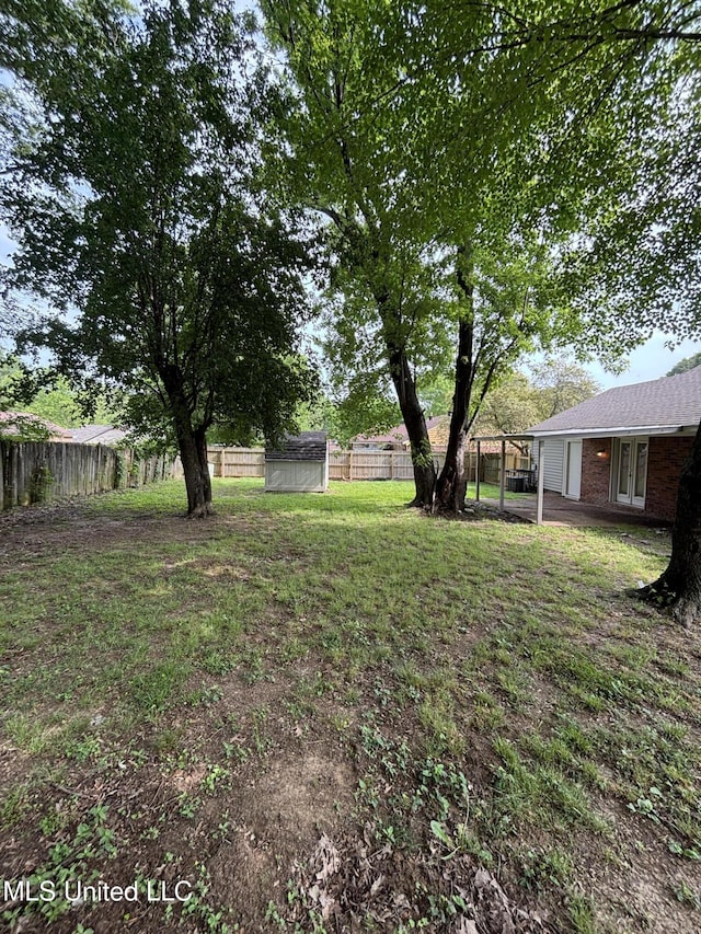 6405 Collinwood Rd, Horn Lake, MS 38637 - view of yard with a fenced backyard, an outdoor structure, a shed, and french doors