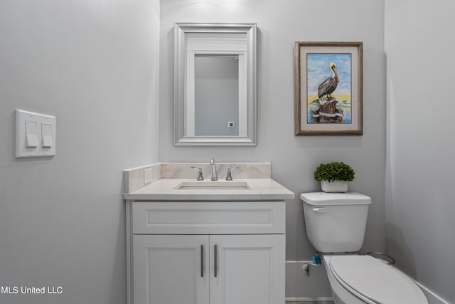 bathroom with toilet and vanity