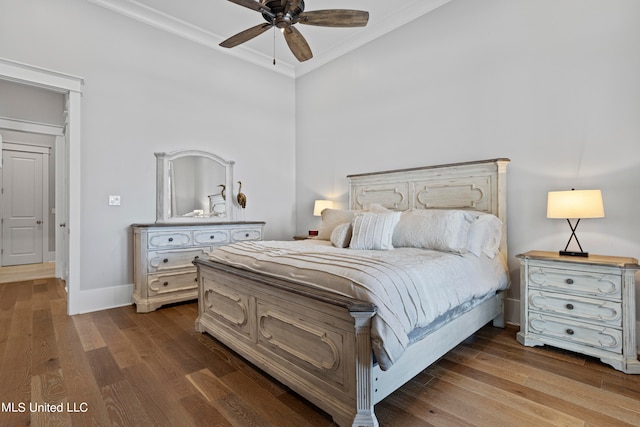 bedroom featuring dark wood-type flooring, ceiling fan, and ornamental molding