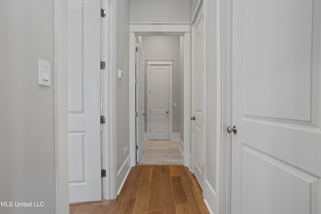 corridor with light hardwood / wood-style flooring