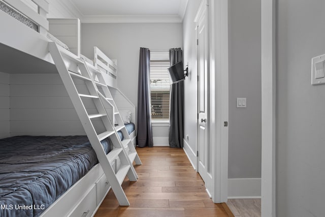 bedroom with hardwood / wood-style flooring and ornamental molding