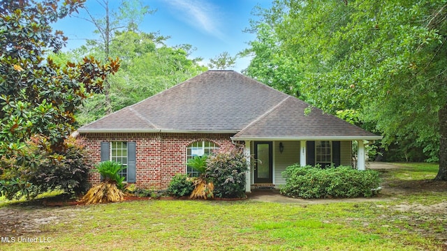 129 E Sunnybrook Rd, Carriere, MS 39426 - view of front of house with a front lawn, roof with shingles, brick siding, and covered porch