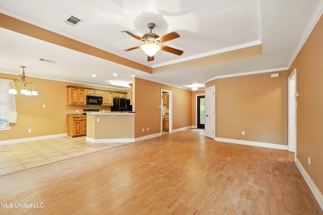 129 E Sunnybrook Rd, Carriere, MS 39426 - unfurnished living room featuring a tray ceiling, light wood-style floors, ornamental molding, ceiling fan, and a chandelier