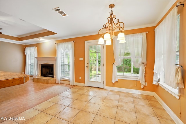 129 E Sunnybrook Rd, Carriere, MS 39426 - unfurnished dining area featuring a chandelier, tile patterned flooring, ornamental molding, a tile fireplace, and baseboards