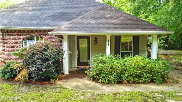 129 E Sunnybrook Rd, Carriere, MS 39426 - view of front of home featuring roof with shingles, covered porch, and brick siding