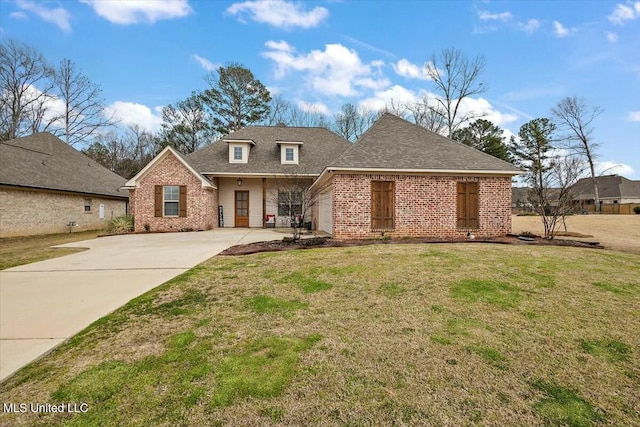 view of front of house with a shingled roof, a front lawn, and brick siding