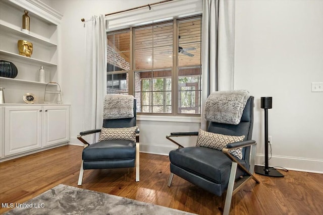 living area with hardwood / wood-style floors and baseboards