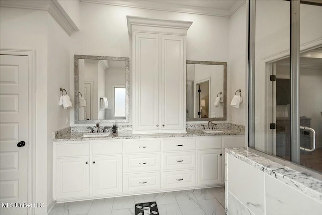 full bathroom with marble finish floor, double vanity, and a sink