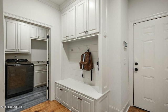 mudroom with ornamental molding, light wood-type flooring, and washer / clothes dryer