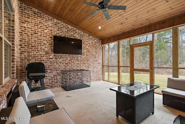 unfurnished sunroom with wooden ceiling, vaulted ceiling, and ceiling fan