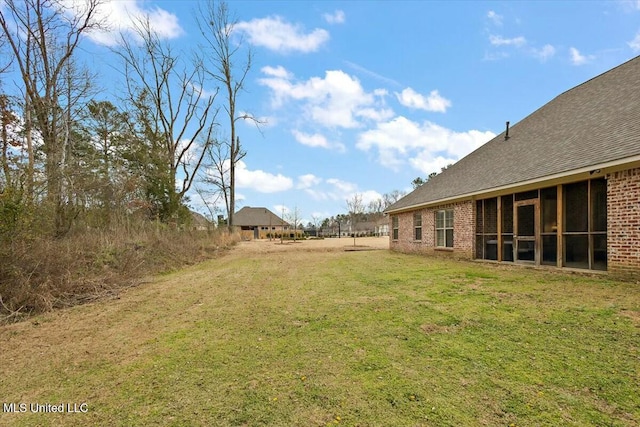 view of yard with a sunroom