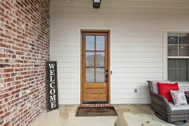 entrance to property with brick siding