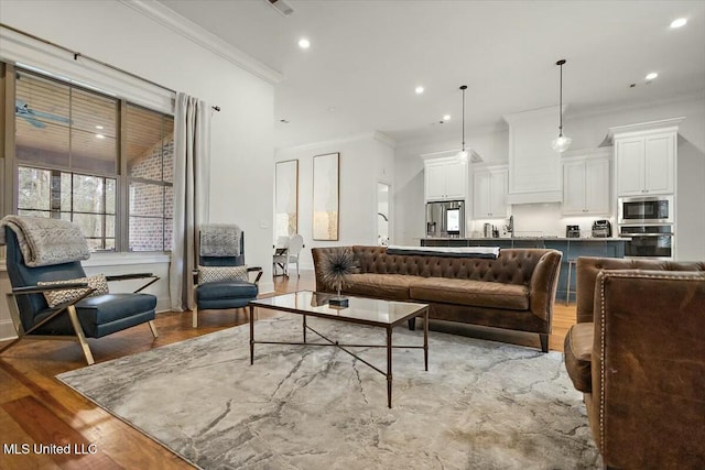 living room featuring recessed lighting, crown molding, and wood finished floors