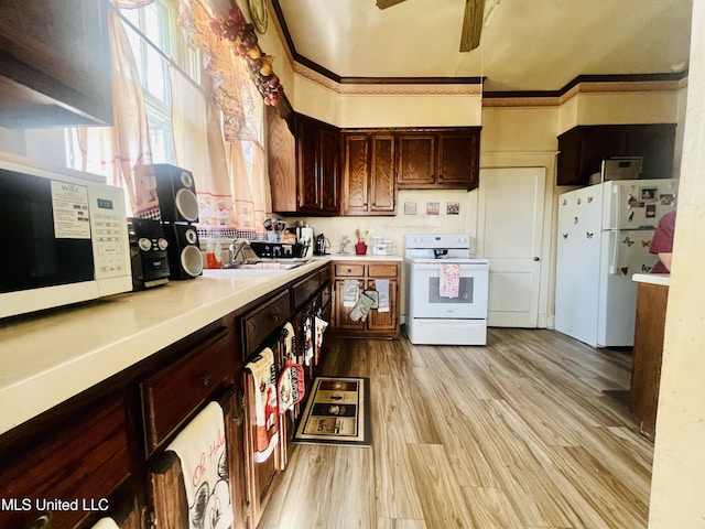 58 Snider St, Grenada, MS 38901 - kitchen with white appliances, light countertops, light wood-style floors, a ceiling fan, and dark brown cabinetry