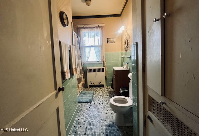 58 Snider St, Grenada, MS 38901 - bathroom featuring radiator, tile walls, vanity, tile patterned floors, and a wainscoted wall