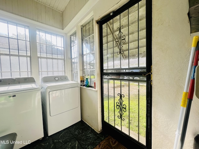 58 Snider St, Grenada, MS 38901 - laundry room featuring washer and dryer, dark marble finish floors, and a textured wall