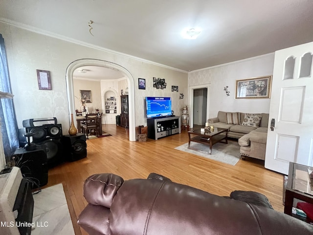 58 Snider St, Grenada, MS 38901 - living room featuring wood finished floors, arched walkways, and crown molding