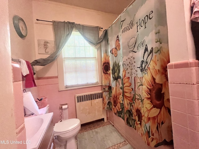 58 Snider St, Grenada, MS 38901 - bathroom featuring radiator heating unit, vanity, tile walls, wainscoting, and shower / tub combo with curtain