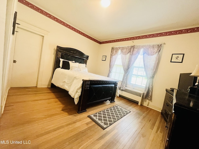 58 Snider St, Grenada, MS 38901 - bedroom featuring radiator heating unit and light wood finished floors