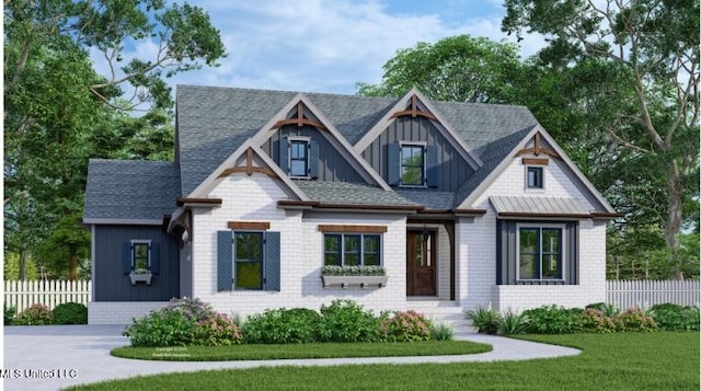 view of front of home featuring fence, board and batten siding, roof with shingles, and a front yard