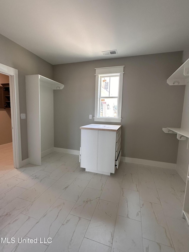 1740 Bakersfield Way, Nesbit, MS 38651 - laundry room with light marble finish flooring and baseboards