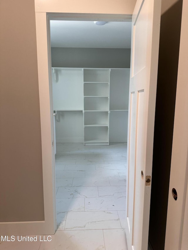 1740 Bakersfield Way, Nesbit, MS 38651 - walk in closet featuring marble look tile flooring