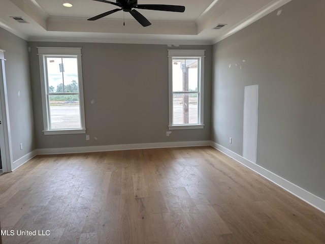 1740 Bakersfield Way, Nesbit, MS 38651 - spare room featuring a raised ceiling, ornamental molding, wood finished floors, and healthy amount of natural light