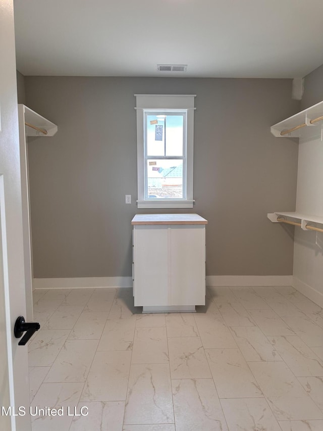 1740 Bakersfield Way, Nesbit, MS 38651 - spacious closet featuring light marble finish flooring