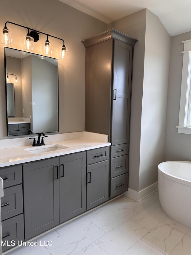 1740 Bakersfield Way, Nesbit, MS 38651 - full bathroom with marble finish floors, a freestanding bath, vanity, and baseboards