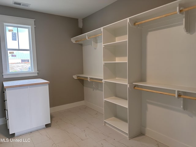 1740 Bakersfield Way, Nesbit, MS 38651 - walk in closet featuring light marble finish flooring