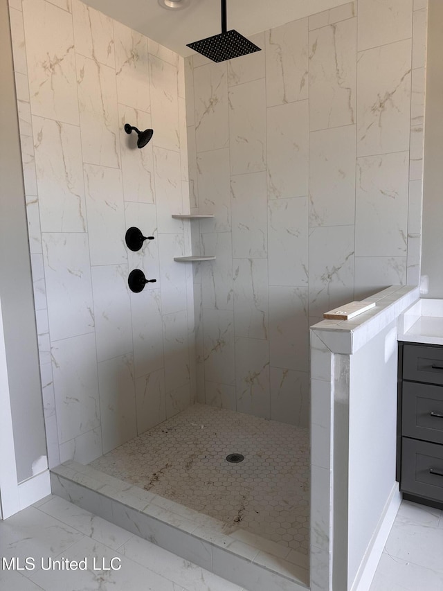 1740 Bakersfield Way, Nesbit, MS 38651 - bathroom featuring marble finish floors, a tile shower, and vanity