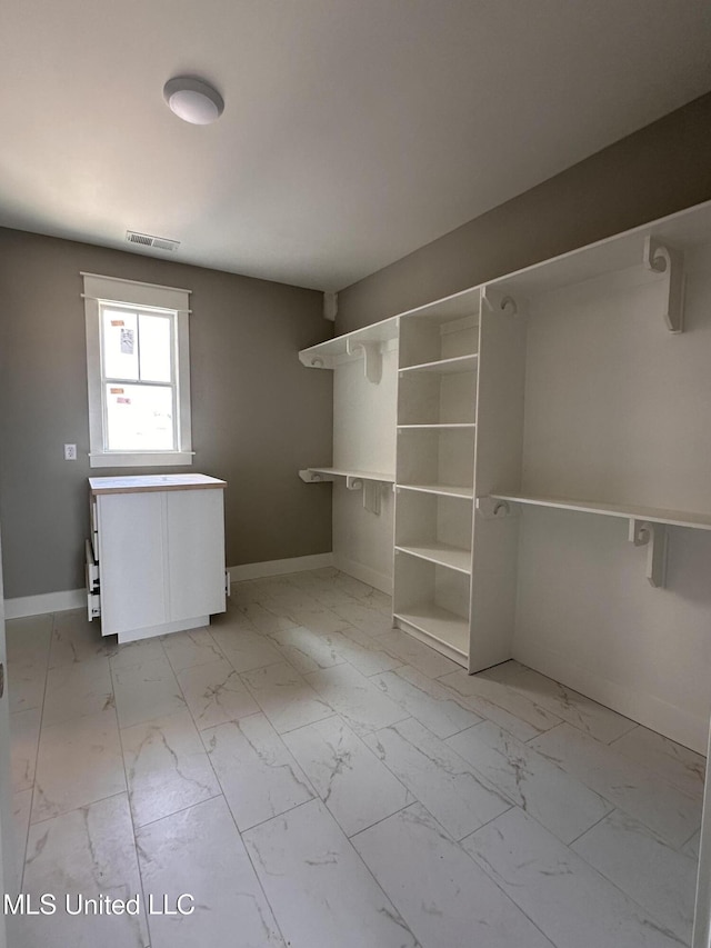 1740 Bakersfield Way, Nesbit, MS 38651 - spacious closet with light marble finish flooring