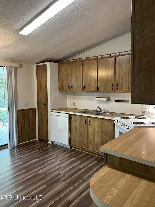97131 Kapalama Dr, Diamondhead, MS 39525 - kitchen featuring white appliances, a sink, vaulted ceiling, a textured ceiling, and dark wood finished floors