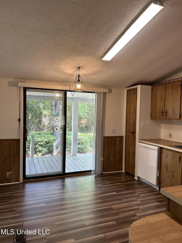 97131 Kapalama Dr, Diamondhead, MS 39525 - kitchen featuring white dishwasher, a textured ceiling, dark wood finished floors, a wainscoted wall, and brown cabinetry