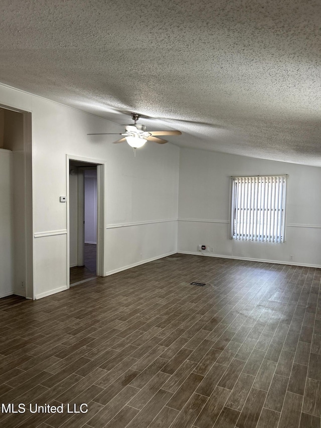 97131 Kapalama Dr, Diamondhead, MS 39525 - empty room featuring ceiling fan, a textured ceiling, dark wood finished floors, and baseboards