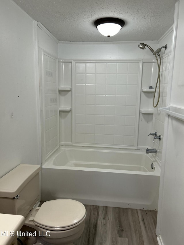 97131 Kapalama Dr, Diamondhead, MS 39525 - bathroom featuring toilet, wood finished floors, a textured ceiling, and shower / washtub combination