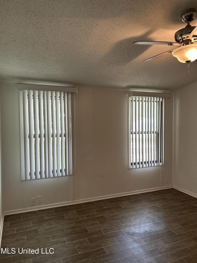 97131 Kapalama Dr, Diamondhead, MS 39525 - spare room with a textured ceiling, dark wood finished floors, a ceiling fan, and baseboards