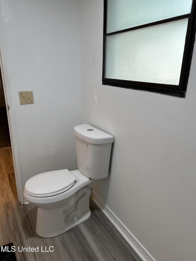 97131 Kapalama Dr, Diamondhead, MS 39525 - bathroom featuring wood finished floors, baseboards, and toilet