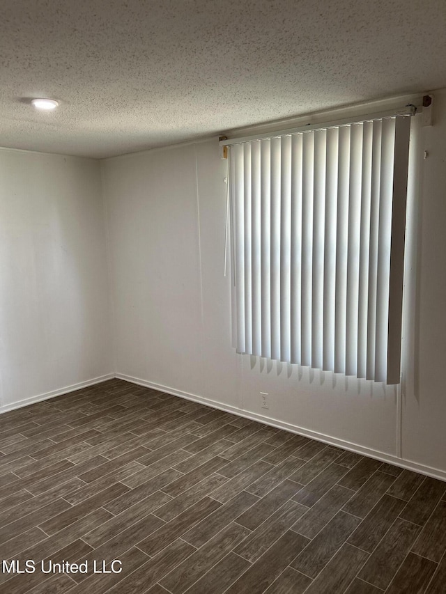 97131 Kapalama Dr, Diamondhead, MS 39525 - spare room with dark wood finished floors, a textured ceiling, and baseboards