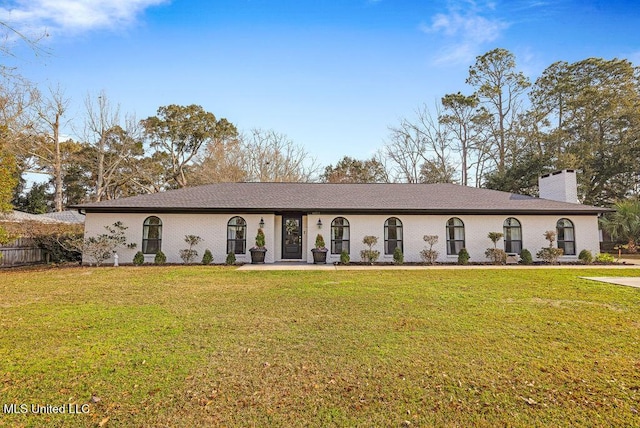 view of front of property with a chimney and a front yard