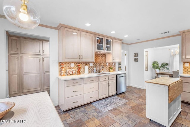 kitchen with pendant lighting, light brown cabinetry, sink, wooden counters, and stainless steel dishwasher