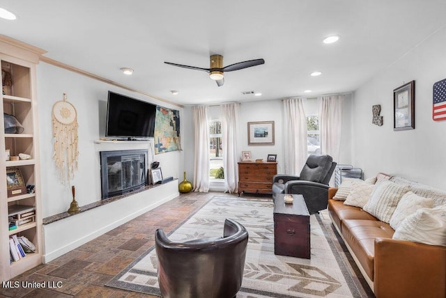 living room featuring crown molding and ceiling fan