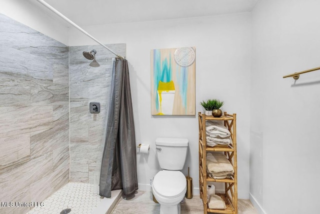 bathroom featuring curtained shower and toilet