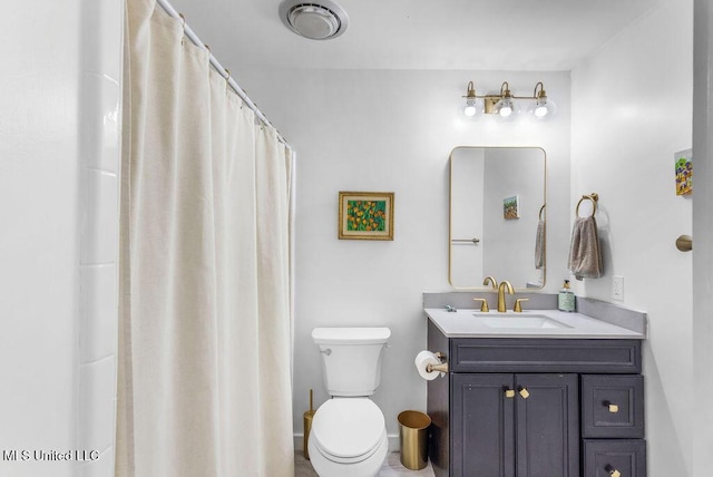 bathroom with vanity, toilet, and walk in shower