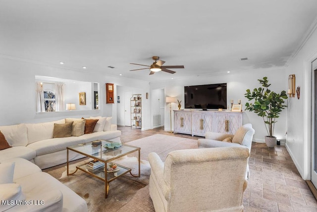 living room featuring ornamental molding and ceiling fan