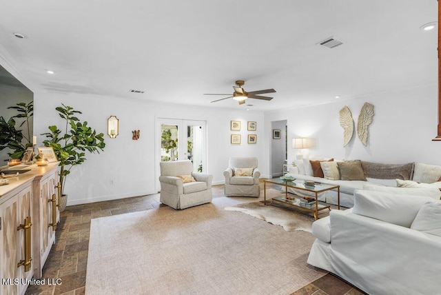 living room featuring ceiling fan and french doors