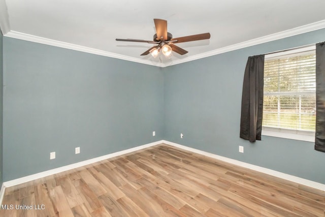 empty room with ceiling fan, wood finished floors, baseboards, and ornamental molding